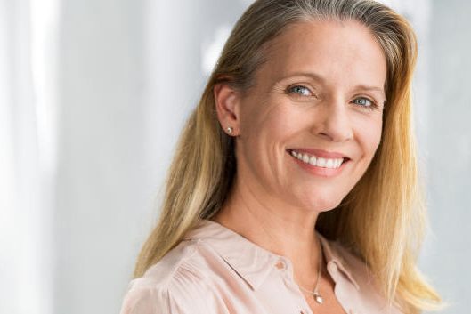 Mature woman with dental implants Mature woman with dental implants