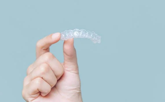 Man holding invisalign brace