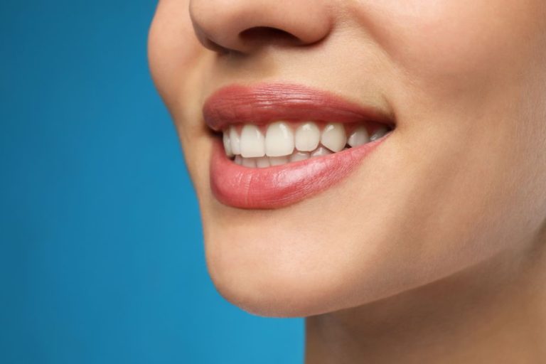 Woman with Healthy Teeth and Beautiful Smile on Blue Background, Closeup Woman with Healthy Teeth and Beautiful Smile on Blue Background, Closeup
